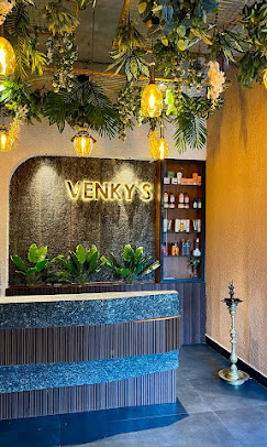 Venky's salon reception with golden signage